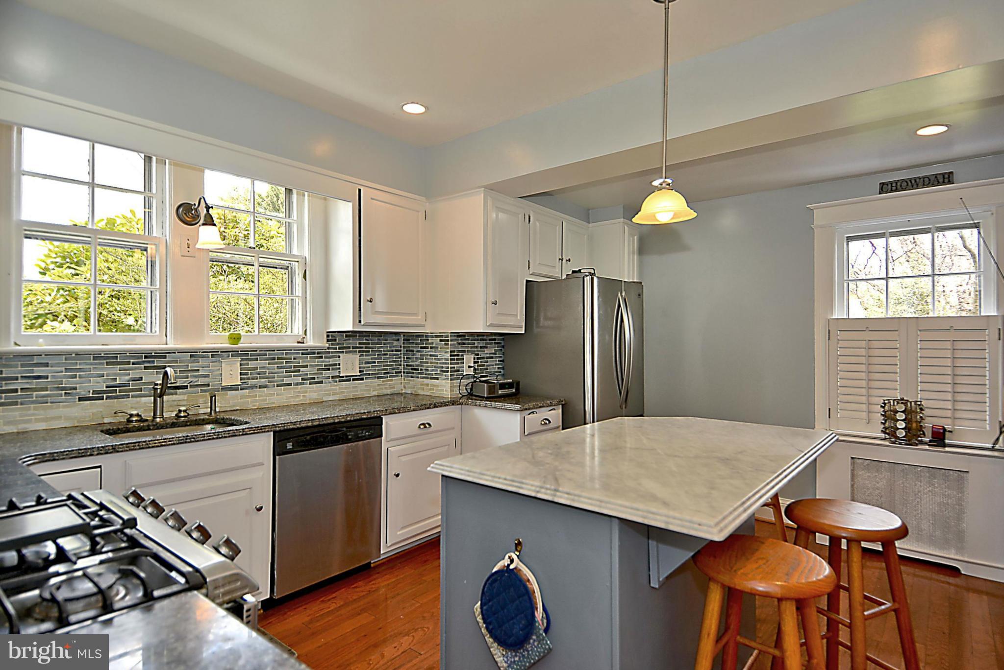 1909 Stratton Road Silver Spring, MD 20910 - Photo 7 of 22 a kitchen with stainless steel appliances granite countertop a sink stove and refrigerator