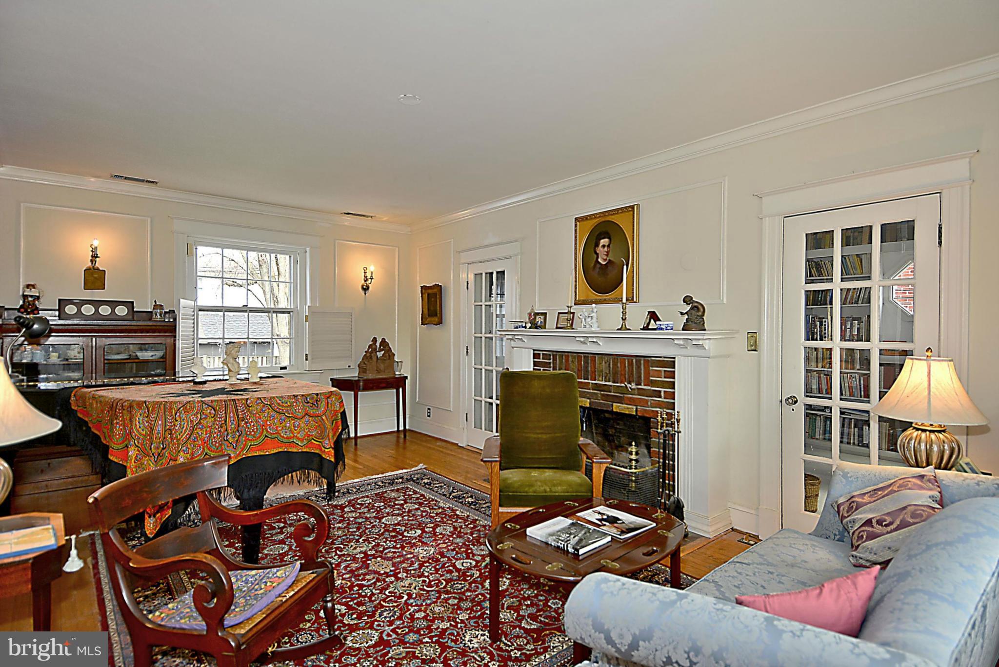 1909 Stratton Road Silver Spring, MD 20910 - Photo 9 of 22 a living room with furniture a flat screen tv and a fireplace