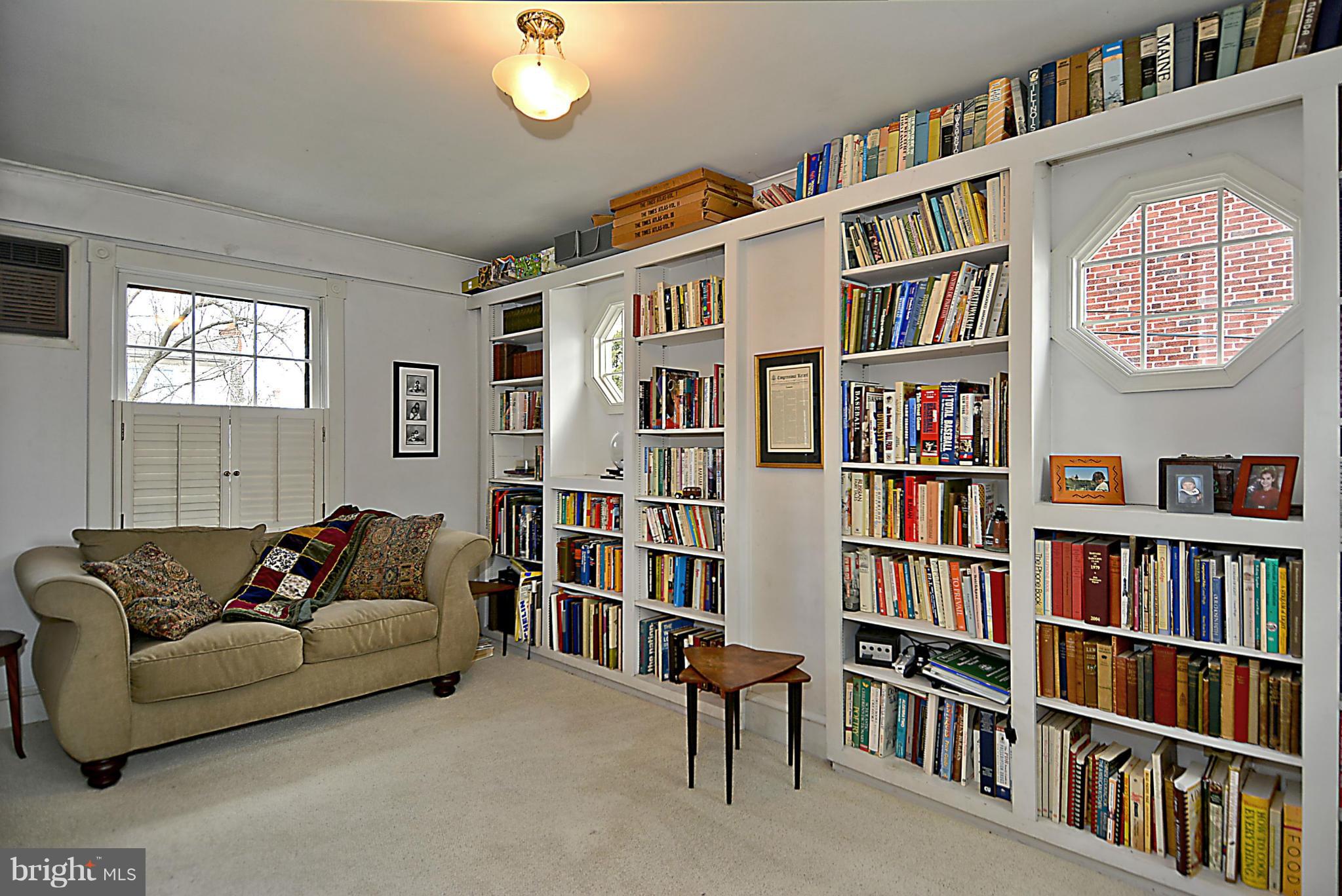 1909 Stratton Road Silver Spring, MD 20910 - Photo 10 of 22 a living room with a book shelf and a book shelf