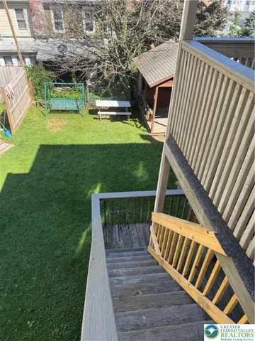 a view of a wooden deck and a yard