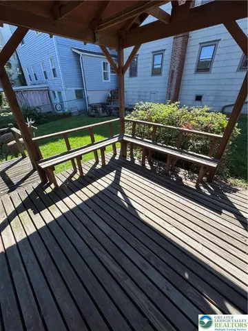 a view of a room with furniture and wooden floor