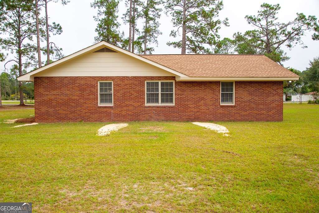 503 Satilla Church Road Baxley, GA 31513 - Photo 14 of 70 a front view of a house with a yard