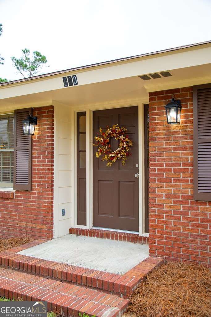 503 Satilla Church Road Baxley, GA 31513 - Photo 18 of 70 a view of a brick house with a outdoor space