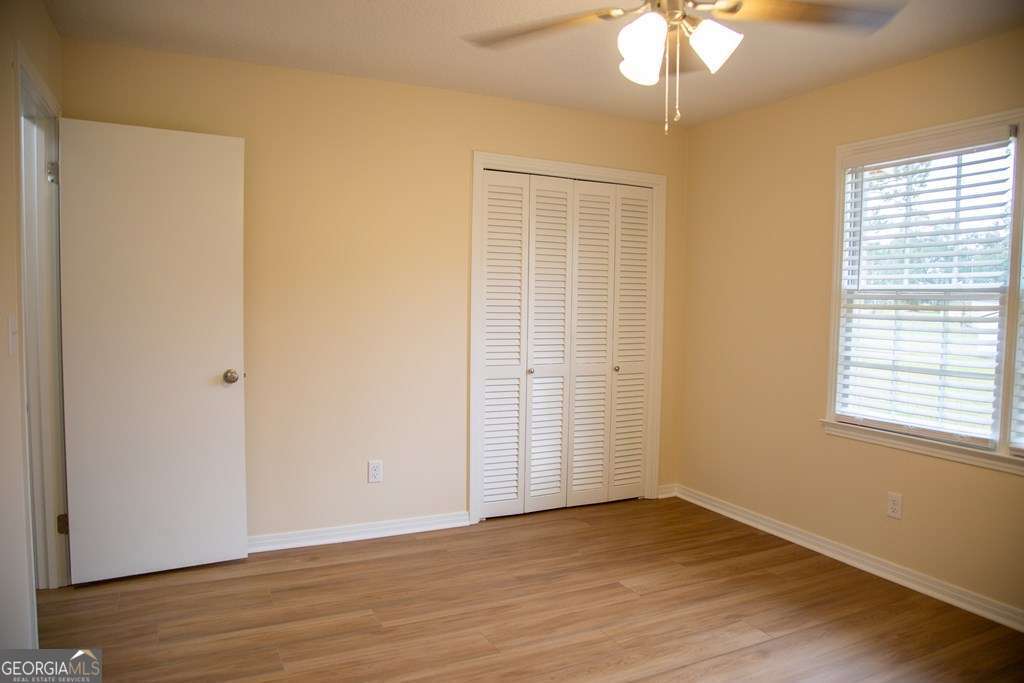 503 Satilla Church Road Baxley, GA 31513 - Photo 24 of 70 a view of an empty room with wooden floor and a window