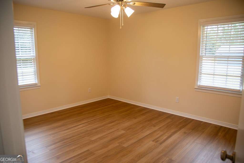 503 Satilla Church Road Baxley, GA 31513 - Photo 27 of 70 wooden floor in an empty room with a window