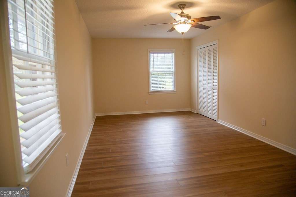 503 Satilla Church Road Baxley, GA 31513 - Photo 29 of 70 wooden floor in an empty room with a window