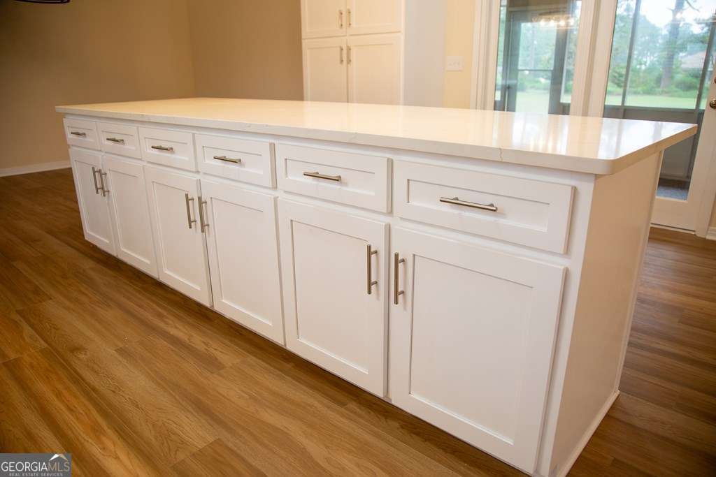 503 Satilla Church Road Baxley, GA 31513 - Photo 38 of 70 a room with white cabinets and wooden floor