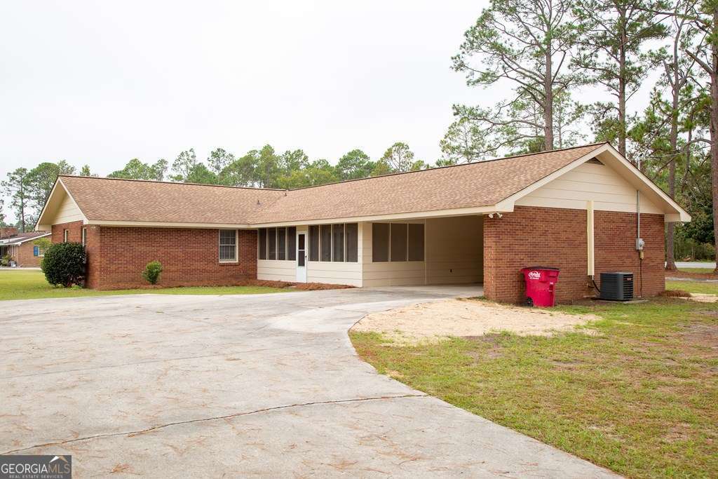 503 Satilla Church Road Baxley, GA 31513 - Photo 4 of 70 a front view of a house with an outdoor space and seating area