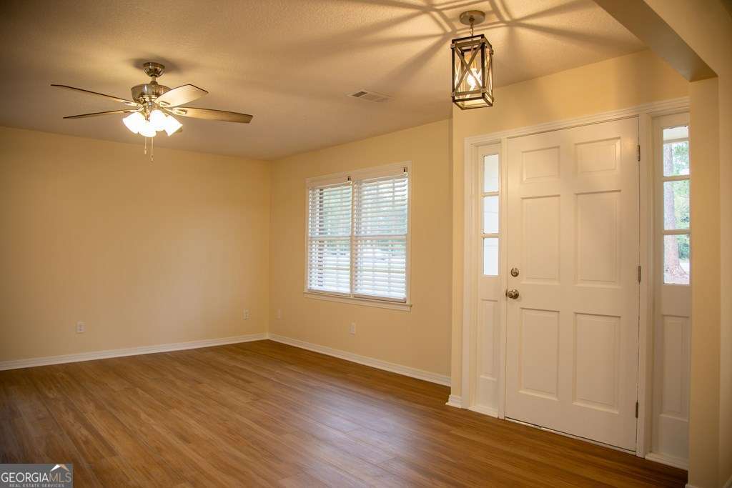 503 Satilla Church Road Baxley, GA 31513 - Photo 42 of 70 a view of empty room with wooden floor and fan