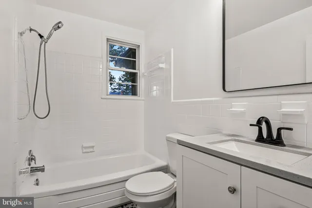 a bathroom with a sink a toilet and a bathtub