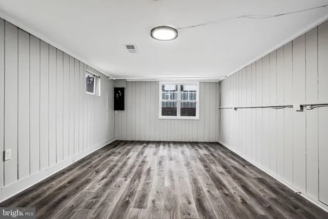 a view of a livingroom with wooden floor and window