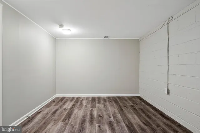a view of a room with wooden floor