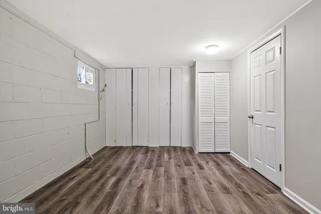 a view of a room with wooden floor and white walls