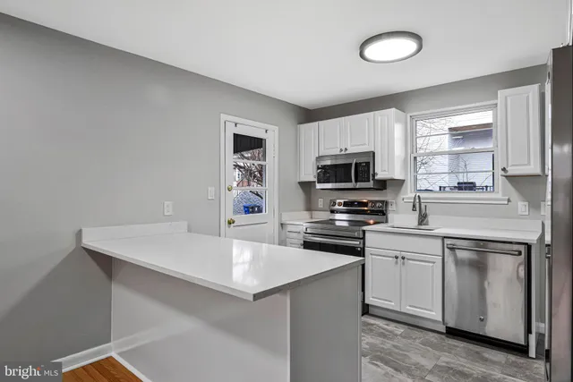 a kitchen with a sink a stove and microwave