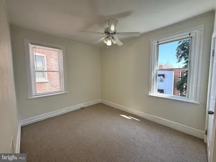 a view of a livingroom with a ceiling fan and window