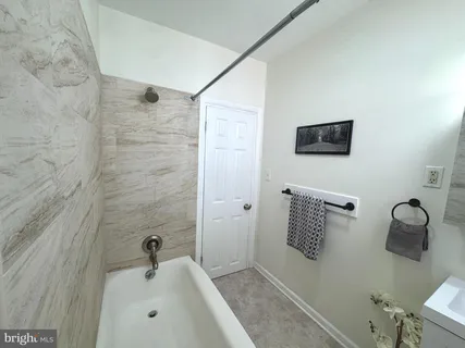 a bathroom with a bathtub and shower