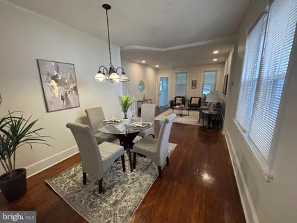 a view of a dining room with furniture window and wooden floor