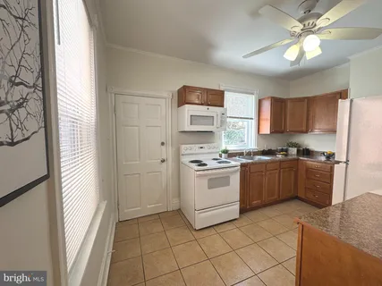 a kitchen with a stove a sink and a refrigerator