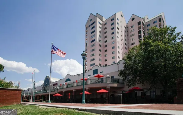 a front view of a building with cars parked