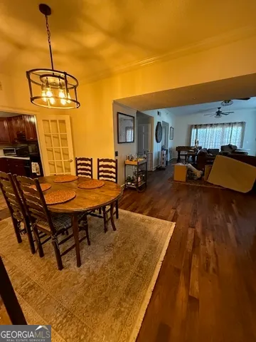 a living room with furniture and a dining table