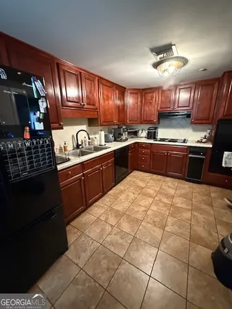 a kitchen with stainless steel appliances granite countertop a stove sink and cabinets