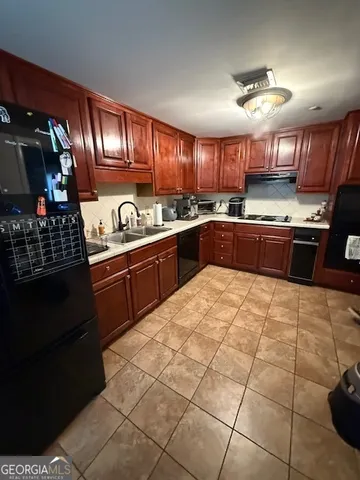 a kitchen with stainless steel appliances granite countertop a stove sink and cabinets