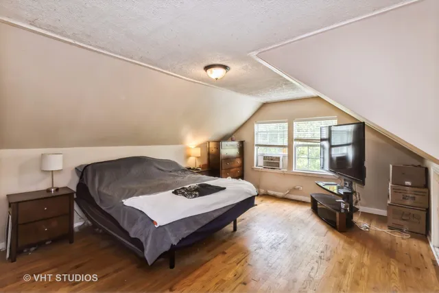 a spacious bedroom with a bed and a large window