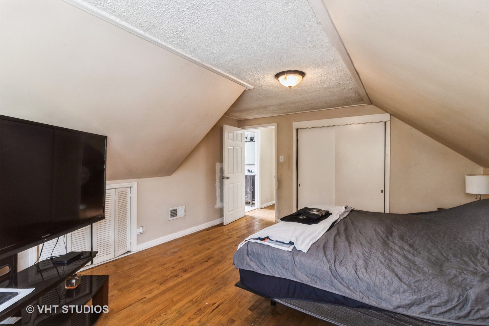 5037 Fargo Avenue Skokie, IL 60077 - Photo 14 of 20 a bedroom with a bed and a flat screen tv