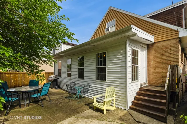 a view of a house with backyard and sitting area