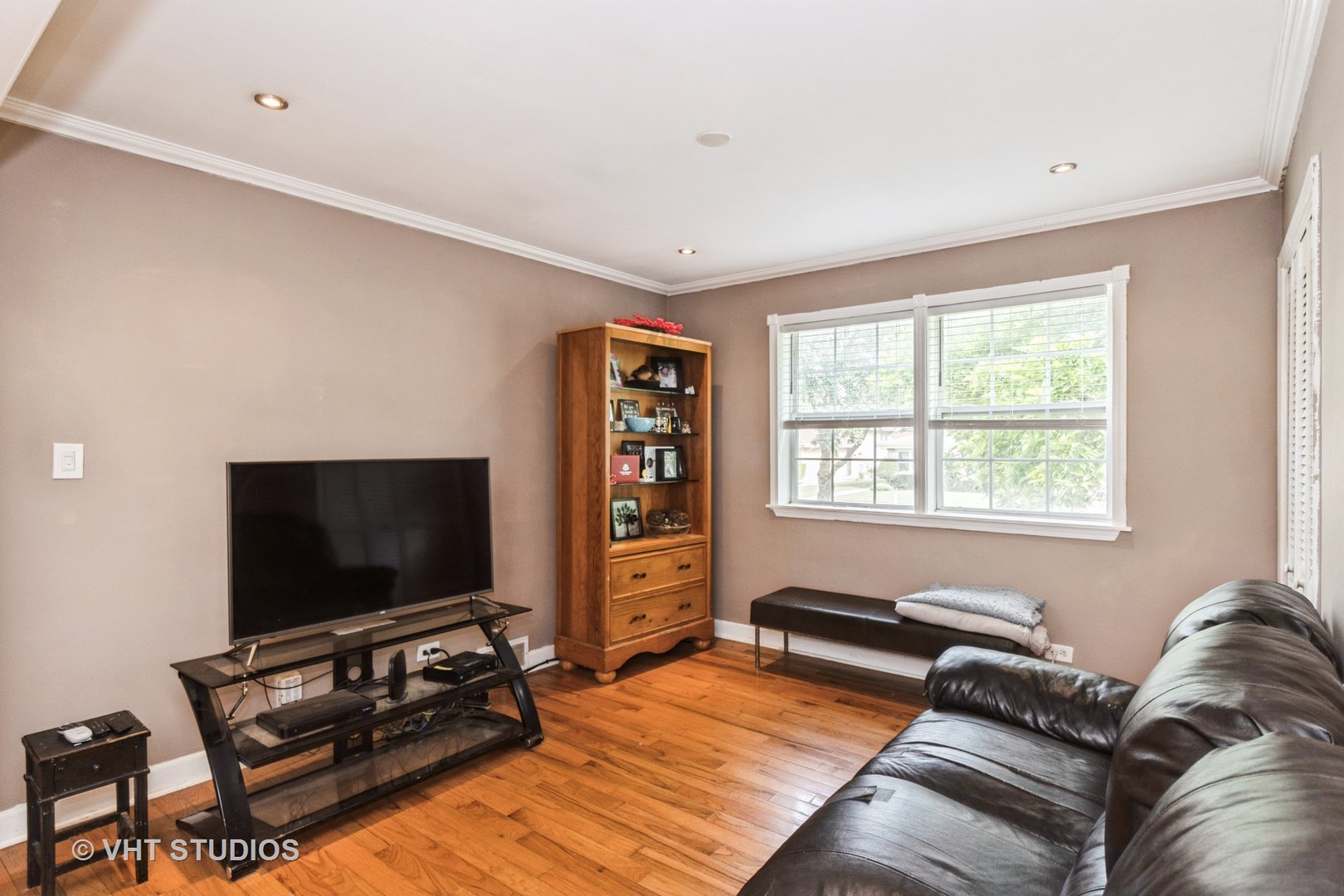 5037 Fargo Avenue Skokie, IL 60077 - Photo 4 of 20 a living room with furniture and a flat screen tv