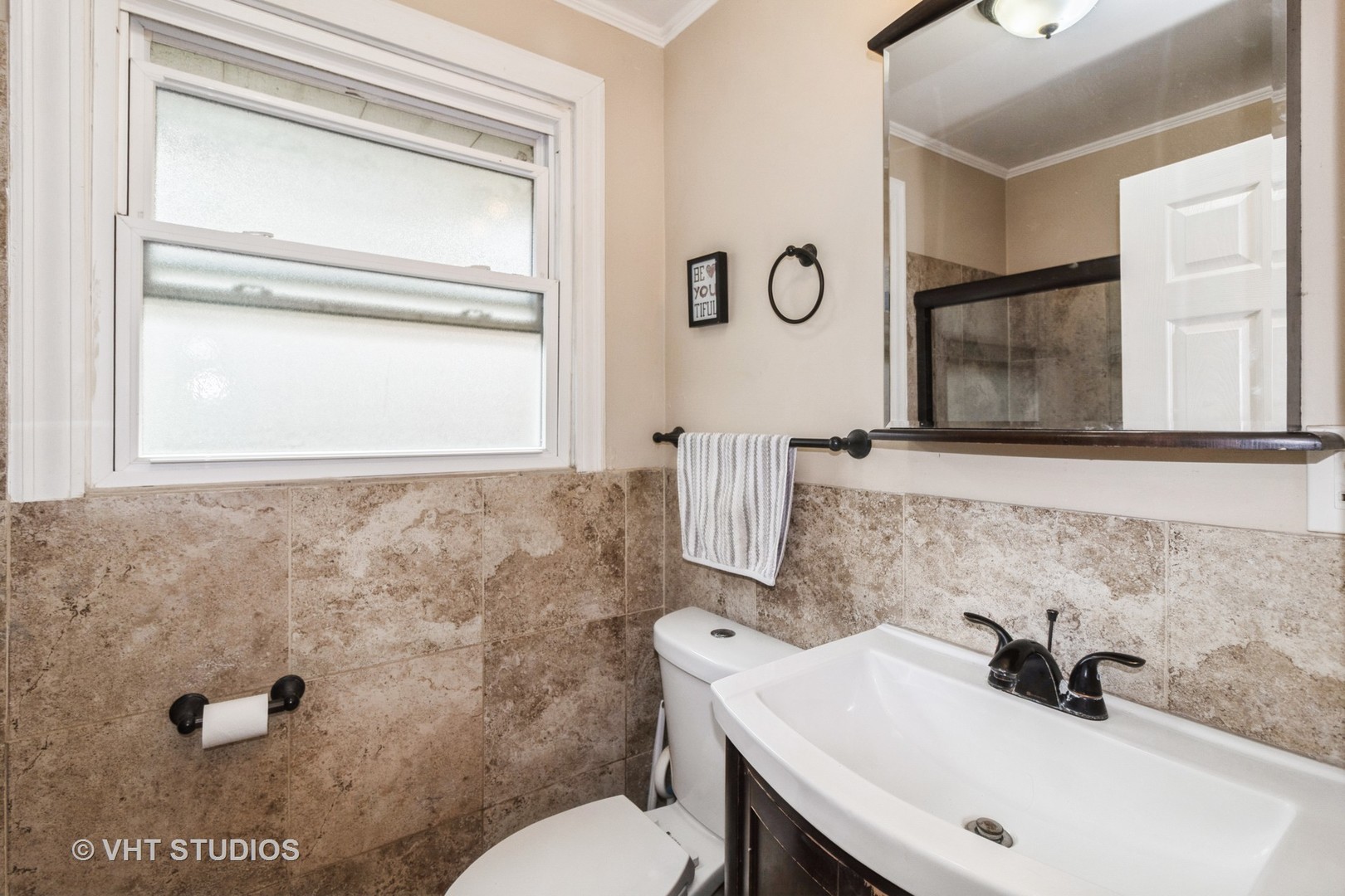 5037 Fargo Avenue Skokie, IL 60077 - Photo 6 of 20 a bathroom with a sink a toilet and a mirror