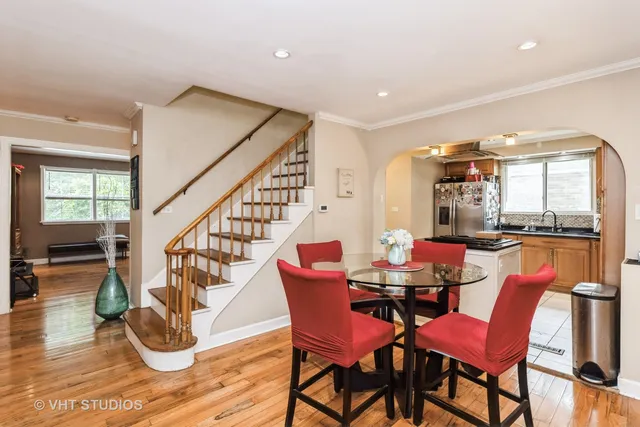 a dining room with furniture window and wooden floor