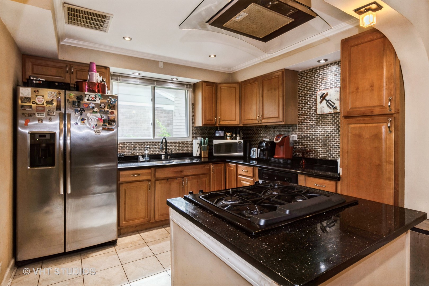 5037 Fargo Avenue Skokie, IL 60077 - Photo 9 of 20 a kitchen with granite countertop a stove sink and refrigerator
