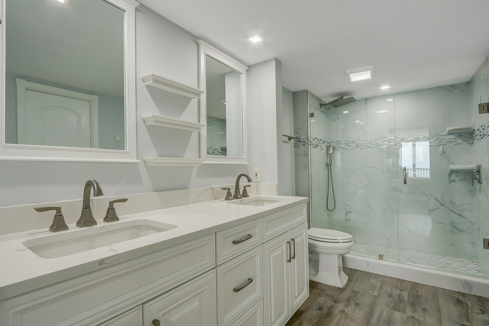 200 South Beach Road, Unit 802 Tequesta, FL 33469 - Photo 32 of 48 a bathroom with a double vanity sink toilet and shower