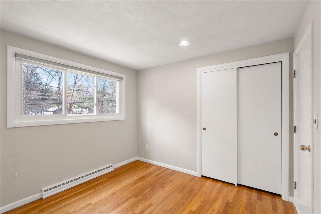 30 Hampton Road Sharon, MA 02067 - Photo 14 of 29 an empty room with wooden floor and windows