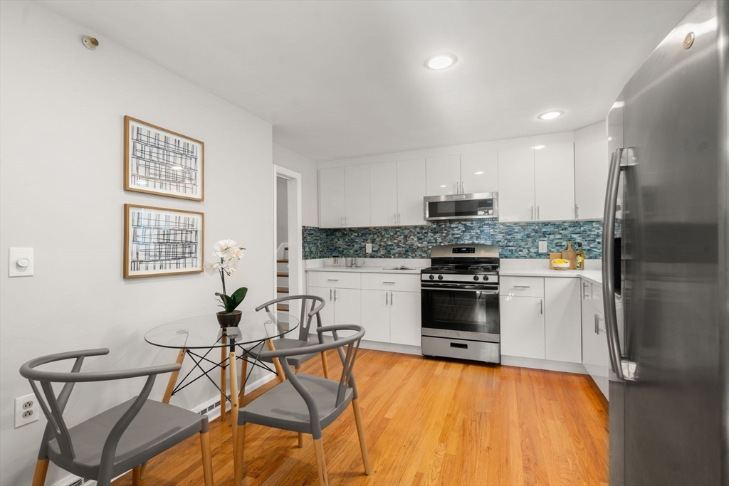 30 Hampton Road Sharon, MA 02067 - Photo 7 of 29 a kitchen with stainless steel appliances granite countertop a stove and a refrigerator