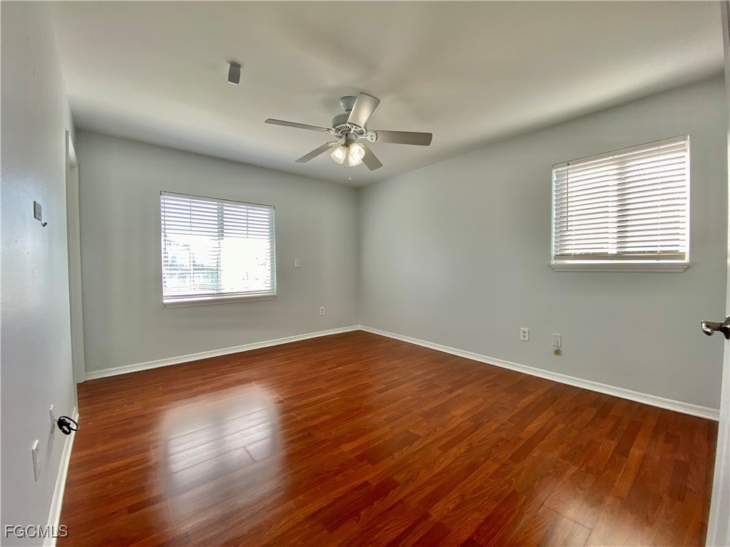 260 13th Street Southwest Naples, FL 34117 - Photo 19 of 29 a view of an empty room with wooden floor and a window