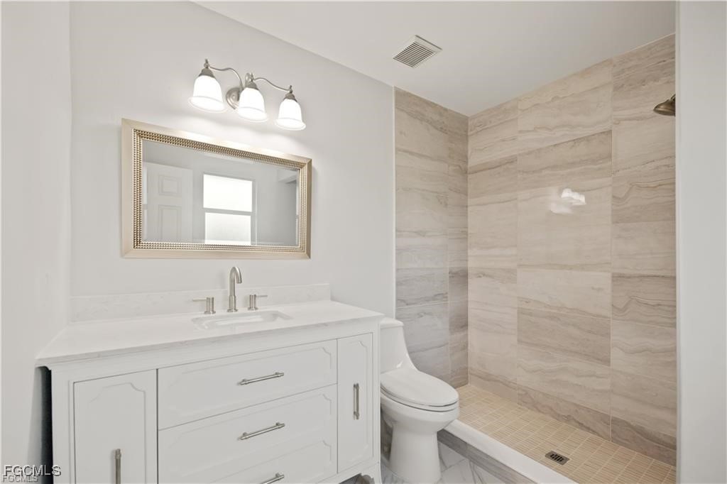 260 13th Street Southwest Naples, FL 34117 - Photo 21 of 29 a bathroom with a sink a toilet and shower