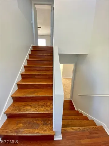 a bedroom with a bed and a dresser next to a window