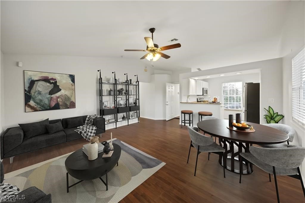 260 13th Street Southwest Naples, FL 34117 - Photo 7 of 29 a living room with furniture kitchen view and a chandelier