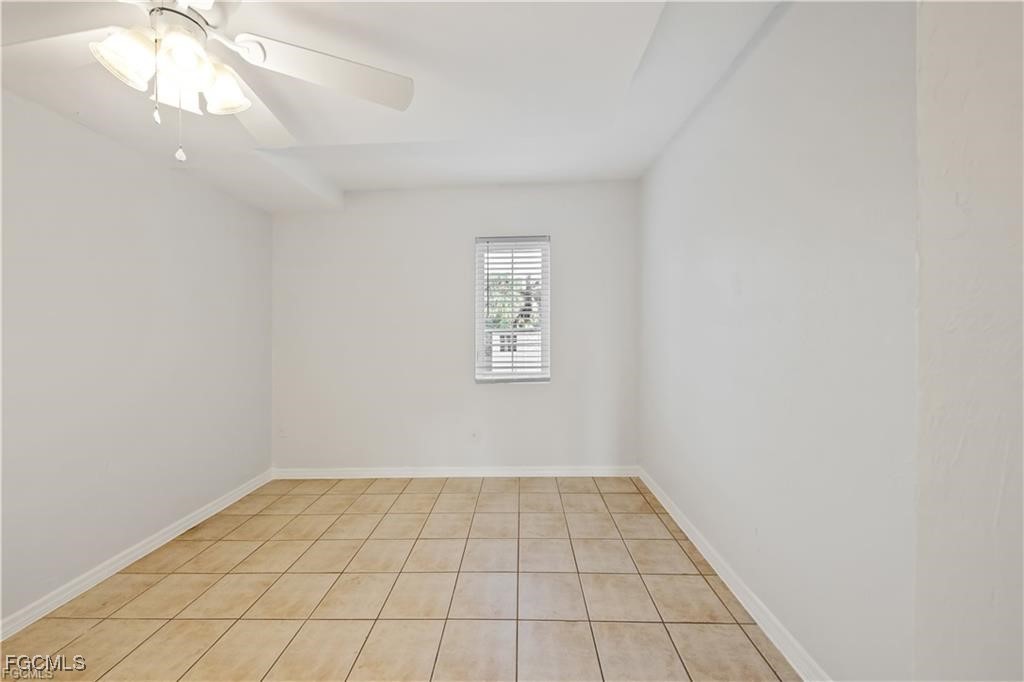 260 13th Street Southwest Naples, FL 34117 - Photo 9 of 29 wooden floor in an empty room with a window