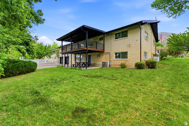 871 Bonita Way Centerville, UT 84014 - Photo 47 of 61 Rear exterior featuring a two-story design with a brick facade