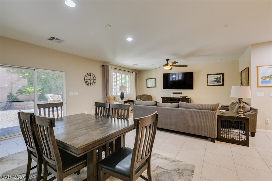 7375 Campbell Ranch Avenue Las Vegas, NV 89179 - Photo 14 of 45 Bright, open-concept living and dining areas offer seamless indoor-outdoor access through sliding glass doors.