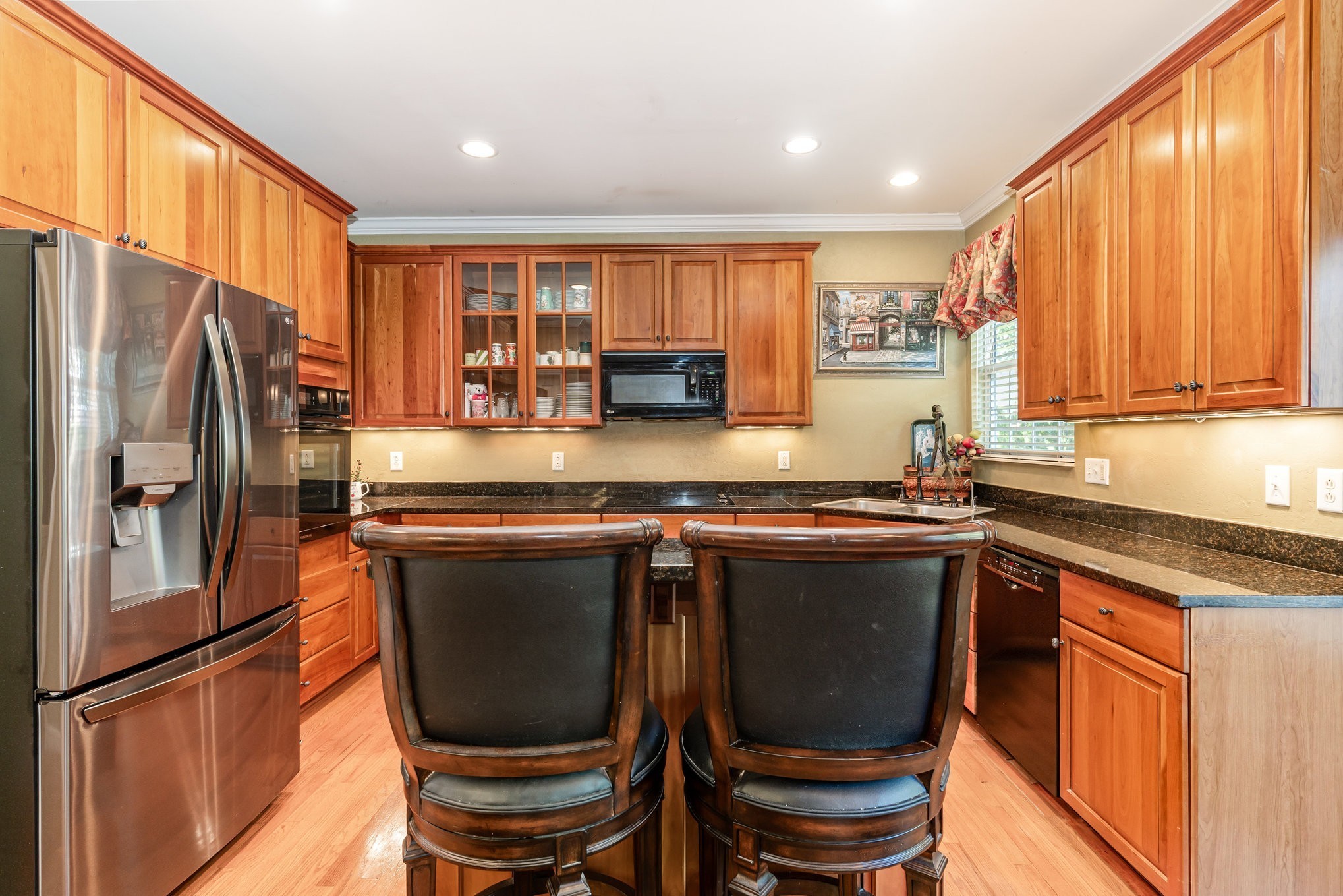224 Logans Circle Franklin, TN 37067 - Photo 11 of 41 a kitchen with stainless steel appliances granite countertop a refrigerator a sink dishwasher a stove and white cabinets with wooden floor