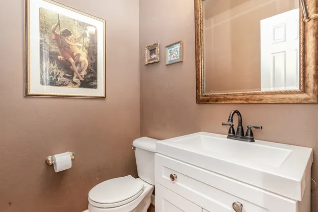 a dining room with furniture potted plants and wooden floor