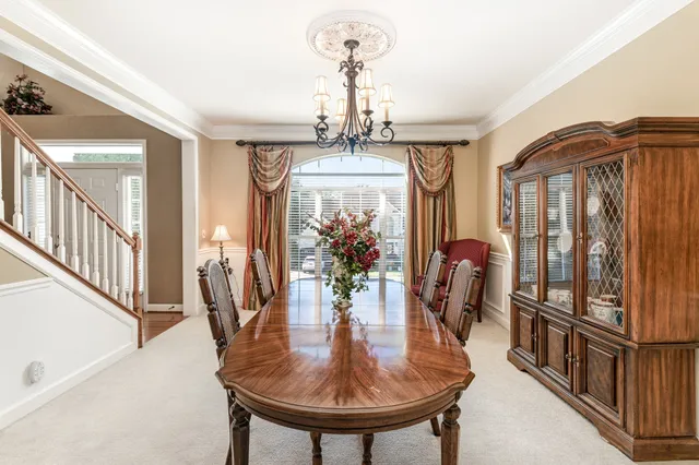 a view of a dining room with furniture and chandelier
