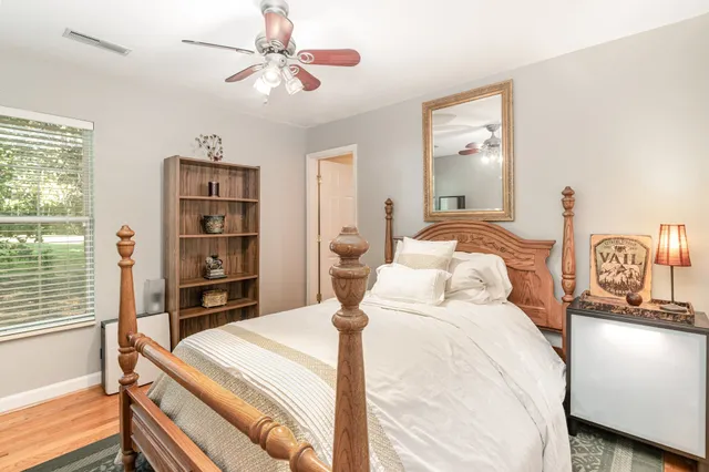 a bedroom with a large bed and a chandelier