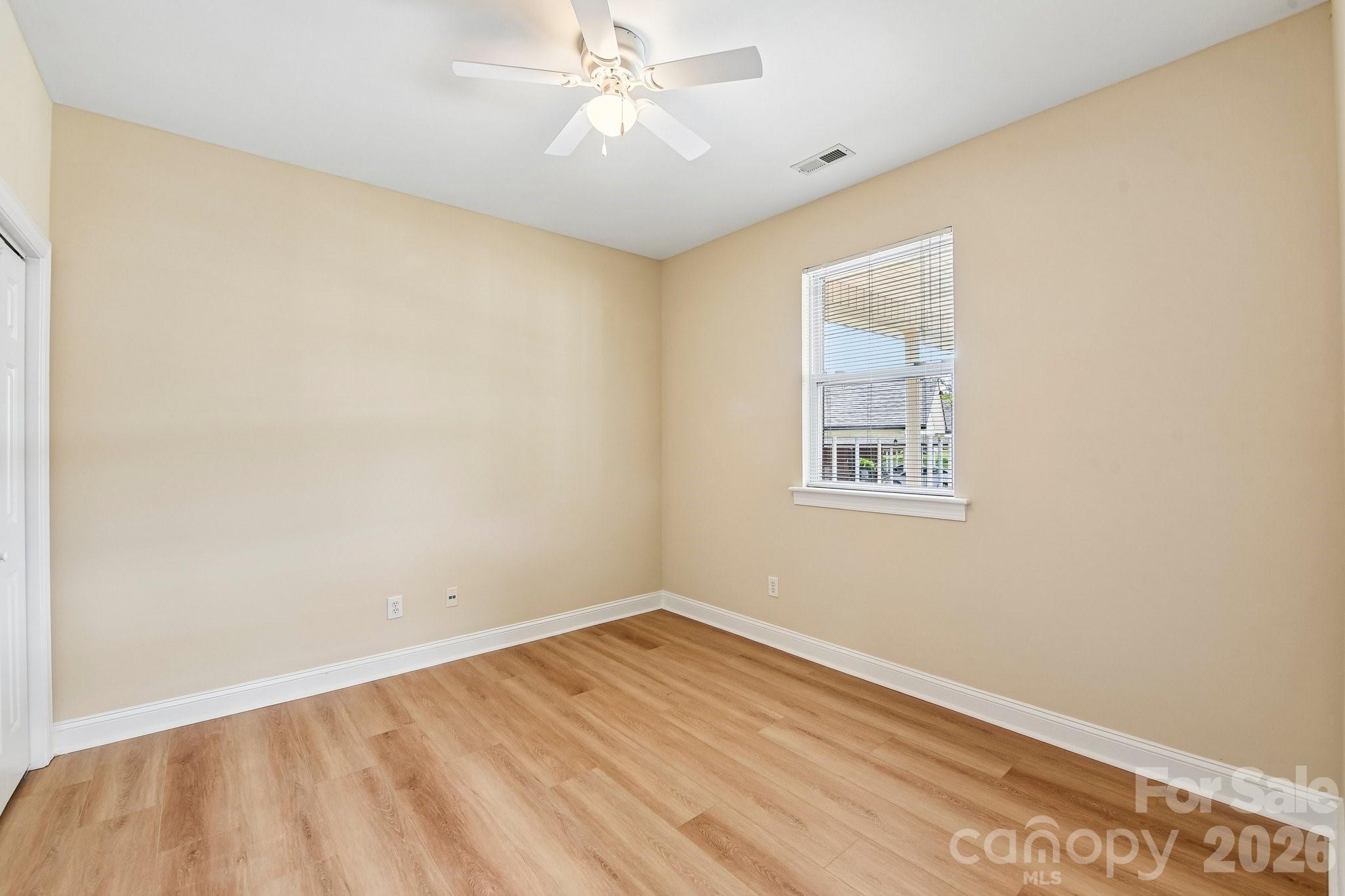 3854 Azalea Trail Denver, NC 28037 - Photo 11 of 22 an empty room with a window and ceiling fan