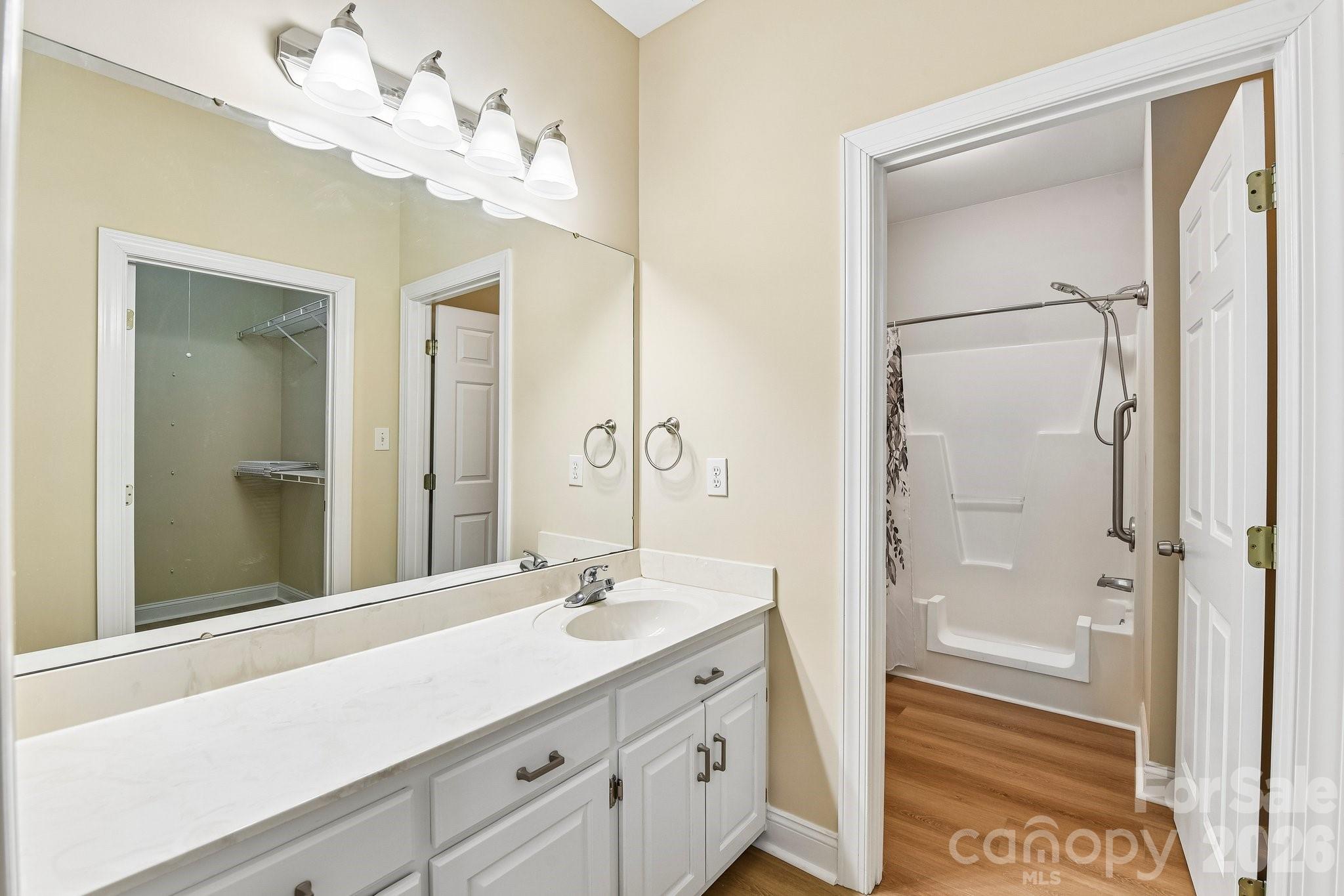 3854 Azalea Trail Denver, NC 28037 - Photo 17 of 22 a bathroom with a double vanity sink mirror and shower