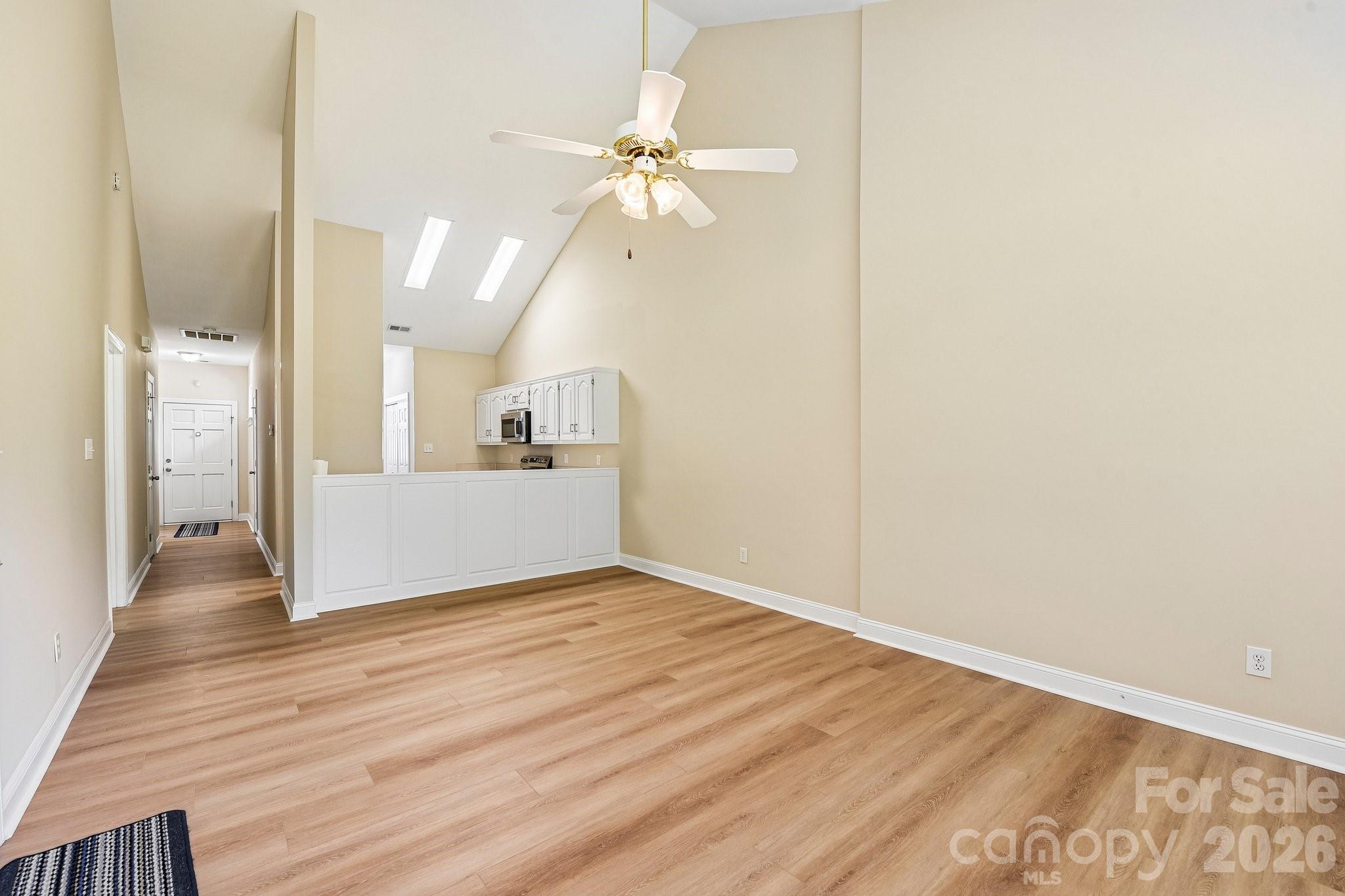 3854 Azalea Trail Denver, NC 28037 - Photo 3 of 22 a view of a room with wooden floor and a ceiling fan